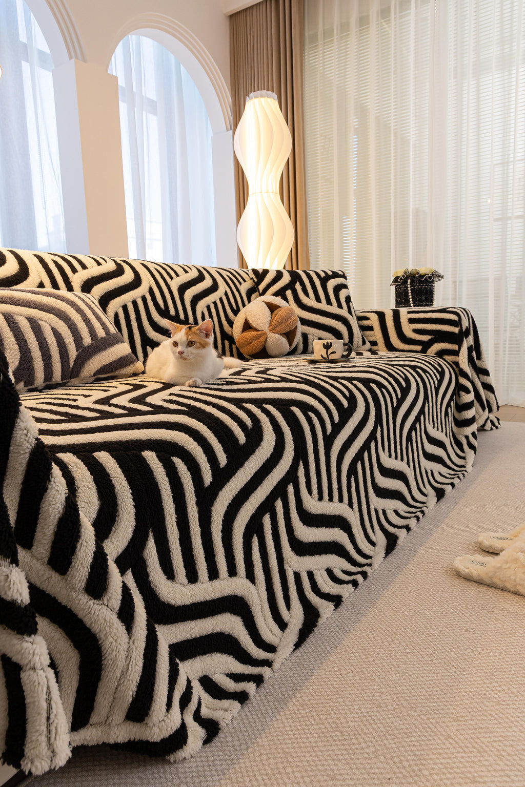 Sofa Decor Riviera Wave Stripe Sofa Cover in Black Cream - styled sofa image for plush patterned couch covers in the UK